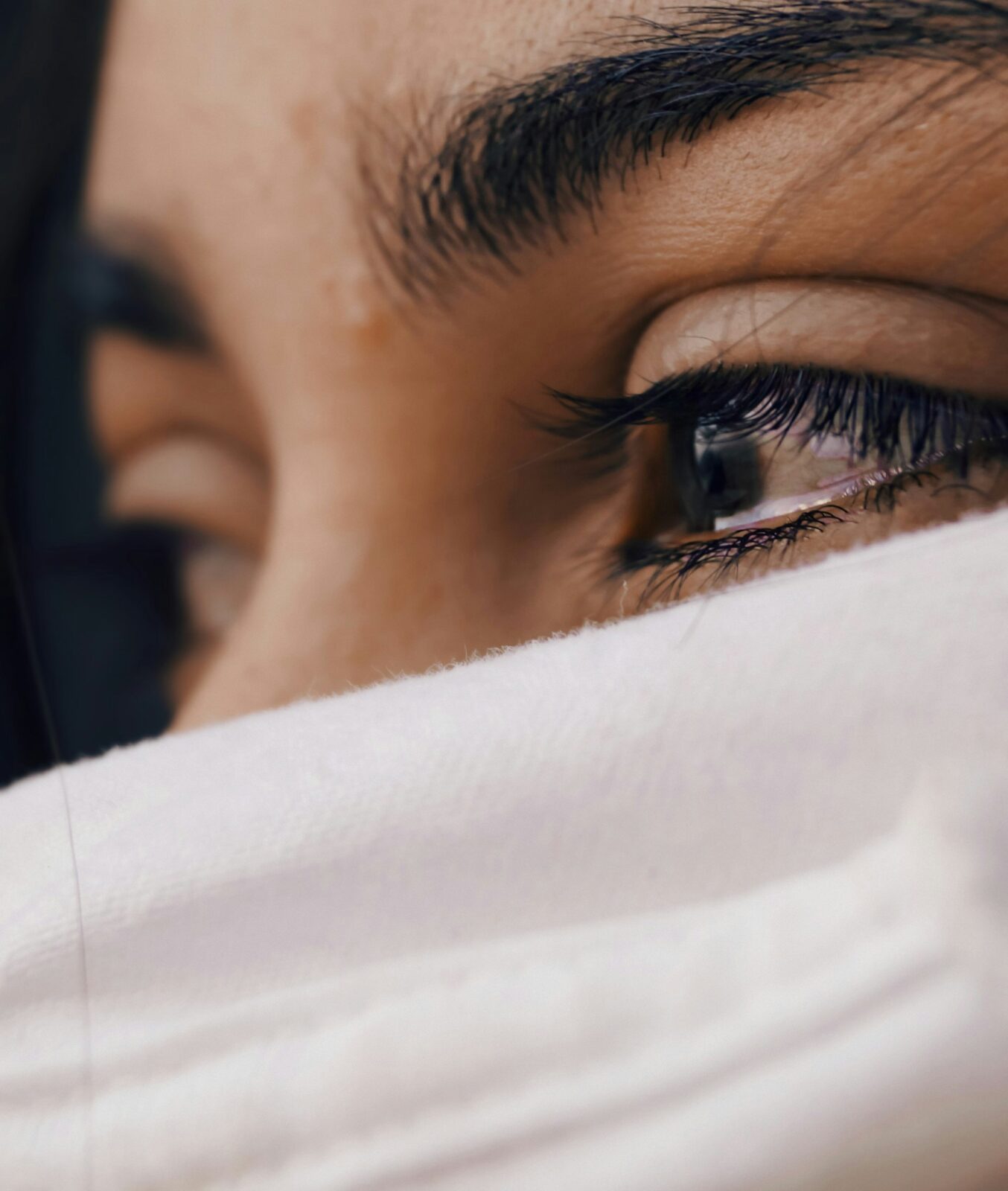 A woman’s eyes brimming with tears.