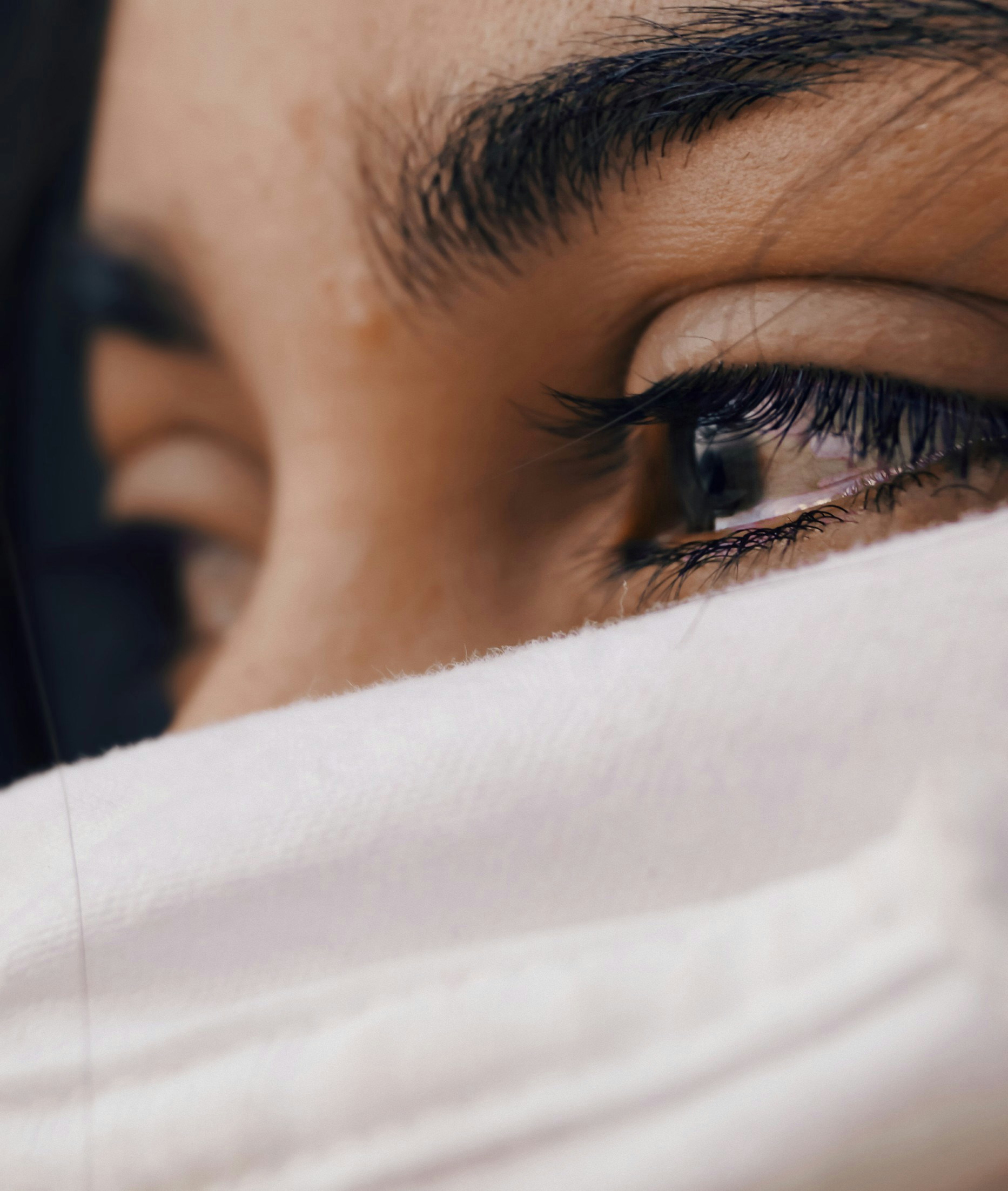 A woman’s eyes brimming with tears.